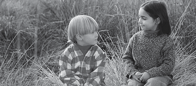 Two Children Sitting Beside Each Other